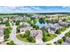 Beautiful aerial view of a residential neighborhood with tree-lined streets and a community pond at 15529 Mission Hills Dr, Carmel, IN 46033