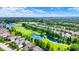 Scenic aerial view showcasing home's proximity to golf course and serene ponds at 15529 Mission Hills Dr, Carmel, IN 46033