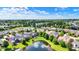 Beautiful aerial view of a lovely neighborhood with mature trees and a pond, offering a serene setting at 15529 Mission Hills Dr, Carmel, IN 46033