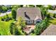 Aerial view of a backyard featuring a stone patio, lush landscaping, and a charming outdoor seating area at 15529 Mission Hills Dr, Carmel, IN 46033