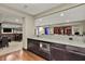 Wet bar featuring modern cabinetry, built-in microwave, and beautiful countertop space at 15529 Mission Hills Dr, Carmel, IN 46033