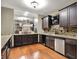 Basement wet bar featuring rich wood cabinetry, modern appliances, and granite countertops at 15529 Mission Hills Dr, Carmel, IN 46033
