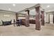 Finished basement featuring a bar area and architectural columns at 15529 Mission Hills Dr, Carmel, IN 46033