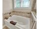 Bathroom featuring soaking tub with decorative tile and a frameless glass shower at 15529 Mission Hills Dr, Carmel, IN 46033