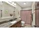 Bathroom with granite countertop, large mirror and patterned shower curtain at 15529 Mission Hills Dr, Carmel, IN 46033