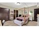 Bright bedroom with a canopy bed, neutral walls, and closet at 15529 Mission Hills Dr, Carmel, IN 46033