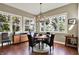 A dining room area with hardwood floors, chandelier, and natural light from the windows at 15529 Mission Hills Dr, Carmel, IN 46033