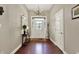 Elegant entryway with hardwood floors, chandelier, and decorative mirror at 15529 Mission Hills Dr, Carmel, IN 46033