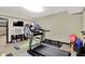 Well-equipped home gym with treadmill, weight bench, and storage at 15529 Mission Hills Dr, Carmel, IN 46033