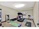 Home gym with workout equipment, including treadmill, weights and yoga mats at 15529 Mission Hills Dr, Carmel, IN 46033