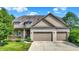 Charming two-story home with a two-car garage, beautiful landscaping and lovely front porch at 15529 Mission Hills Dr, Carmel, IN 46033