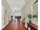 Spacious hallway with hardwood floors, decorative table, and staircase at 15529 Mission Hills Dr, Carmel, IN 46033