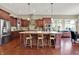 Eat-in kitchen with stainless appliances, granite countertops, seating at the island, and backyard view at 15529 Mission Hills Dr, Carmel, IN 46033