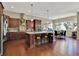 Modern kitchen with dark wood cabinets, granite countertops, stainless appliances, and island seating at 15529 Mission Hills Dr, Carmel, IN 46033