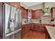 Kitchen showcasing stainless steel appliances, granite countertops, custom wood cabinets, and modern design at 15529 Mission Hills Dr, Carmel, IN 46033