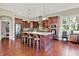 Kitchen featuring granite countertops, stainless appliances, wood cabinets, and natural light from a large window at 15529 Mission Hills Dr, Carmel, IN 46033