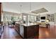 Open kitchen featuring an island with seating, granite countertops and an open-concept to the living room at 15529 Mission Hills Dr, Carmel, IN 46033