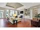 Bright living room with hardwood floors, built-in shelves, and large windows at 15529 Mission Hills Dr, Carmel, IN 46033