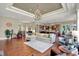 Spacious living room with wood floors, chandelier, fireplace, and open layout to the kitchen at 15529 Mission Hills Dr, Carmel, IN 46033