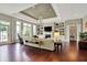 Elegant living room with a fireplace, built-in shelving, and hardwood floors at 15529 Mission Hills Dr, Carmel, IN 46033