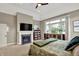 Main bedroom with fireplace, built-ins, and large windows overlooking the backyard at 15529 Mission Hills Dr, Carmel, IN 46033