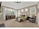 Spacious main bedroom with a large window, ceiling fan, and comfortable seating area at 15529 Mission Hills Dr, Carmel, IN 46033