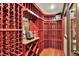 Stunning wine cellar featuring custom racks, wood floors and accent lighting at 15529 Mission Hills Dr, Carmel, IN 46033