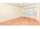 Bedroom boasts laminate flooring, ceiling fan, and a large window for natural light at 15946 Marsala Dr, Fishers, IN 46037