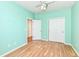Brightly painted bedroom features wood laminate flooring, a ceiling fan, and closet at 15946 Marsala Dr, Fishers, IN 46037