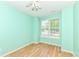 Bright bedroom features wood floors, mint walls, and window bringing in natural light at 15946 Marsala Dr, Fishers, IN 46037