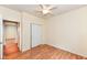 Bedroom featuring wood laminate flooring, a ceiling fan, and a closet at 15946 Marsala Dr, Fishers, IN 46037