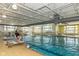 A community indoor pool with a lifeguard on duty and bright overhead lighting at 15946 Marsala Dr, Fishers, IN 46037