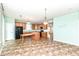 Bright kitchen featuring wood cabinetry, black appliances, island and adjacent dining area at 15946 Marsala Dr, Fishers, IN 46037