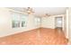 Bright, open living room with wood-look flooring, neutral walls and two ceiling fans at 15946 Marsala Dr, Fishers, IN 46037