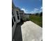 Concrete patio with decorative flowers bordering a well-manicured community lawn under a sunny sky at 15946 Marsala Dr, Fishers, IN 46037
