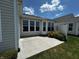 Back patio features a large window-lined wall, a flower garden, and a concrete surface at 15946 Marsala Dr, Fishers, IN 46037