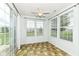 Bright sunroom with tile flooring, ceiling fan, and sliding glass doors to the backyard at 15946 Marsala Dr, Fishers, IN 46037