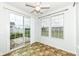 Bright sunroom featuring tile flooring, a ceiling fan, and sliding glass door that leads to a patio at 15946 Marsala Dr, Fishers, IN 46037