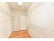 Spacious walk-in closet with custom shelving and laminate wood flooring at 15946 Marsala Dr, Fishers, IN 46037