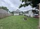 A spacious backyard with a fire pit and shed, partially surrounded by a wooden fence at 1768 N Lynhurst Dr, Speedway, IN 46224
