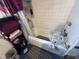 Standard bathroom features a tub with shower and a storage unit for linens at 1768 N Lynhurst Dr, Speedway, IN 46224
