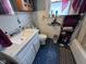 A small bathroom featuring a vanity, toilet, and a shower/tub combo at 1768 N Lynhurst Dr, Speedway, IN 46224