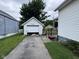 A detached one-car garage with a driveway and grassy areas around it at 1768 N Lynhurst Dr, Speedway, IN 46224