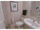 Comfortable powder room with a decorative sink, framed art, and linen-patterned wallpaper at 1870 Broadleaf Ct # 10, Greenwood, IN 46143