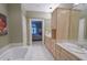 Bright bathroom featuring dual sinks and a soaking tub with views into the bedroom at 1870 Broadleaf Ct # 10, Greenwood, IN 46143