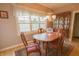 Charming dining area featuring a wood table, china cabinet, and a bright window view at 1870 Broadleaf Ct # 10, Greenwood, IN 46143