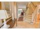 Bright foyer featuring a staircase, marble flooring, a decorative rug, and a console table, creating an elegant entry at 1870 Broadleaf Ct # 10, Greenwood, IN 46143