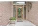 Elegant front entryway with a decorative wreath, a potted plant, and a stylish front door with glass panes at 1870 Broadleaf Ct # 10, Greenwood, IN 46143
