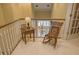 Cozy hallway corner with a rocking chair, side table, and lamp, offering a relaxing space at 1870 Broadleaf Ct # 10, Greenwood, IN 46143