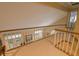 Loft hallway with natural light, wooden railing and view of backyard at 1870 Broadleaf Ct # 10, Greenwood, IN 46143